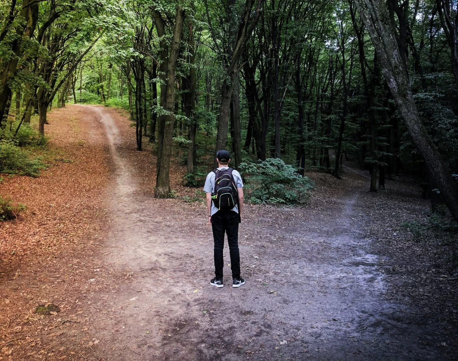 Person facing two roads to depict religious deconstruction therapy