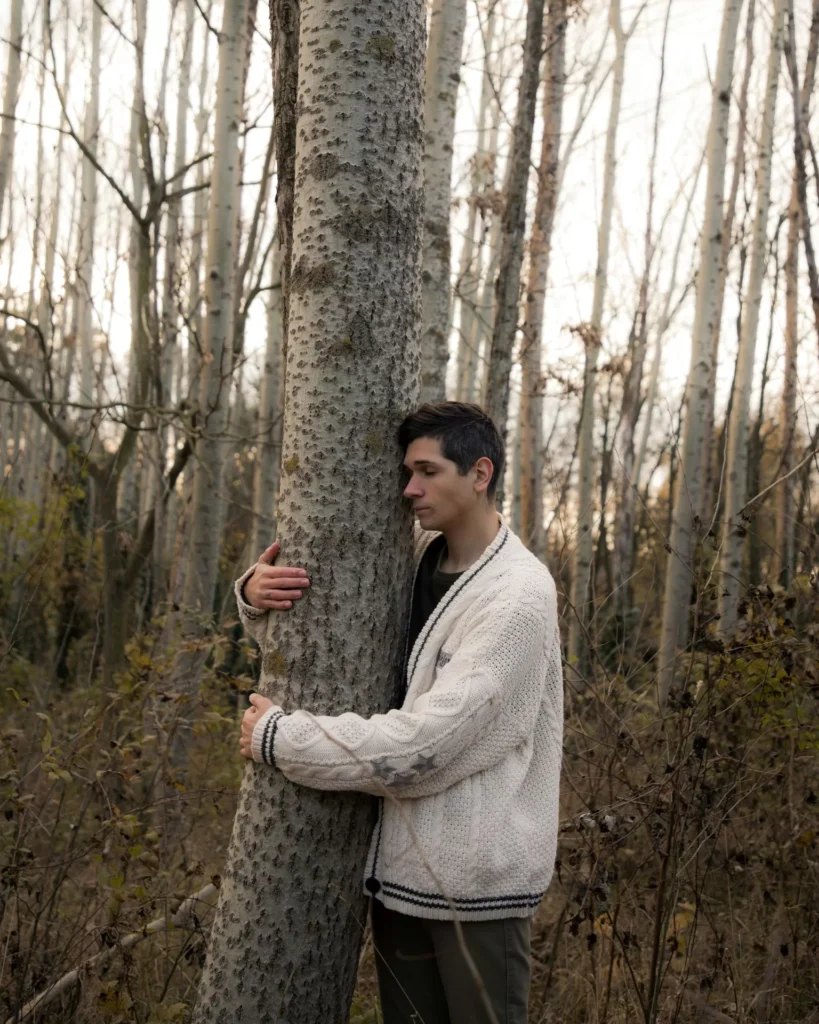 Image of person hugging a tree to represent climate change therapy