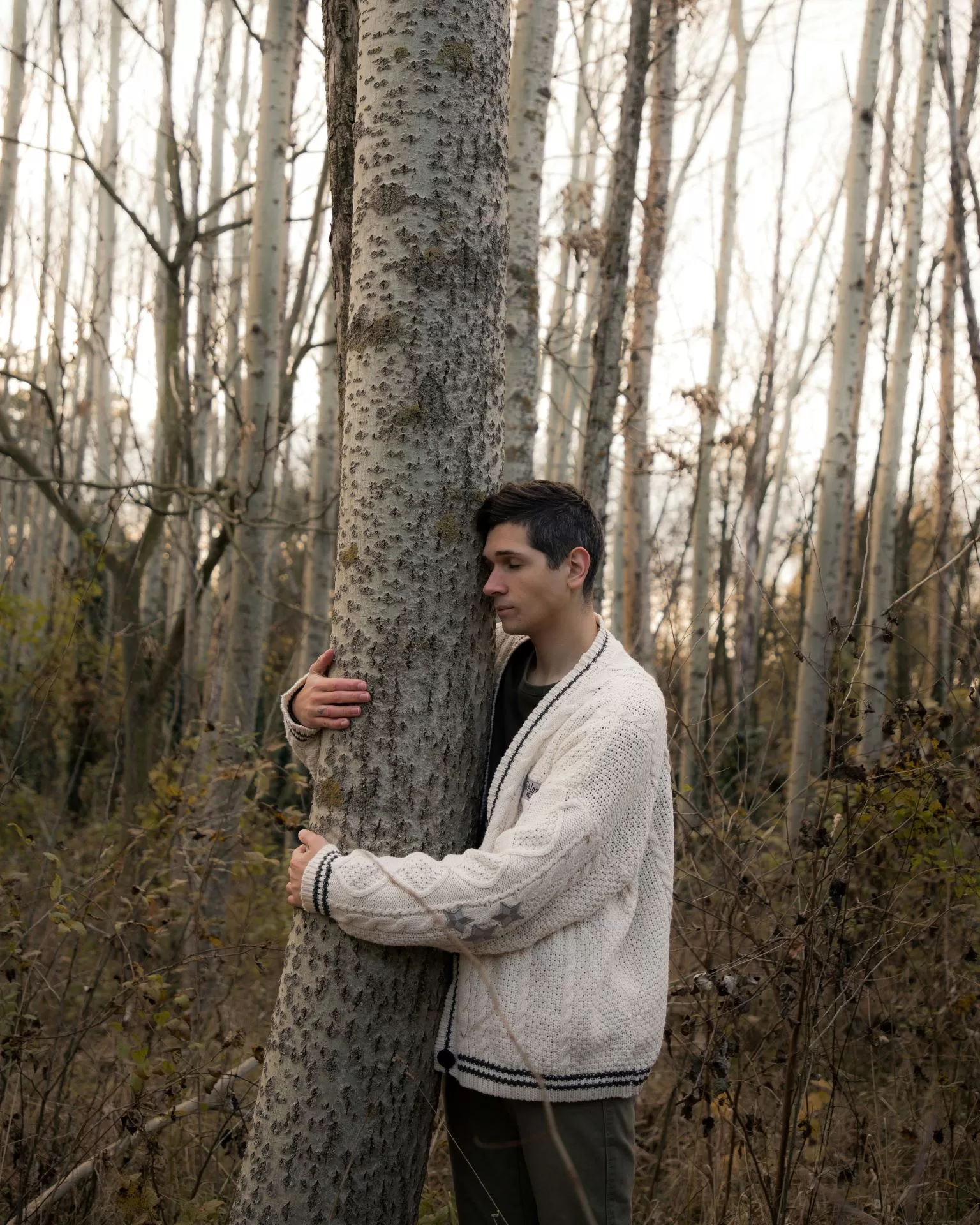 Image of person hugging a tree to represent climate change therapy