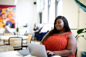 image of a woman searching on a laptop to represent finding a religious trauma therapist